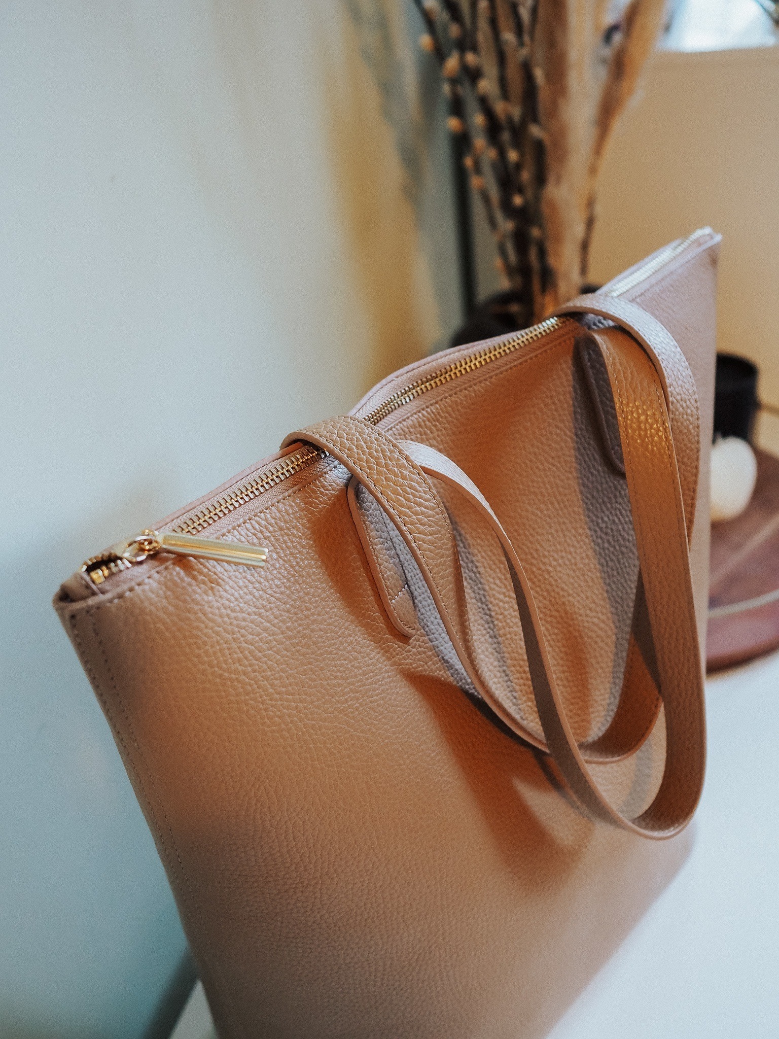 Trying to choose the best Cuyana leather tote? Look no further than the Tall Structured Zipper Tote in this blog post review.
